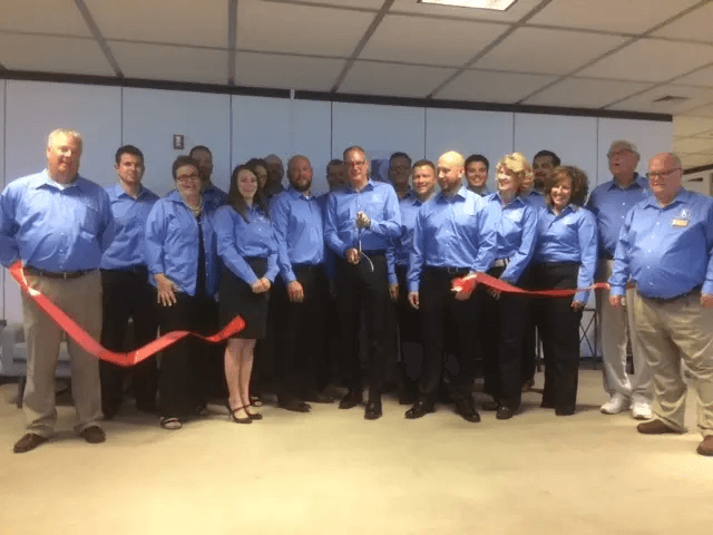 Group of Keller Logistics Group employees cutting a ribbon