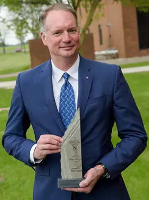 Man posing with award