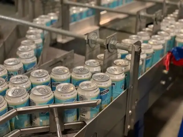 a factory line filled with blue moon cans