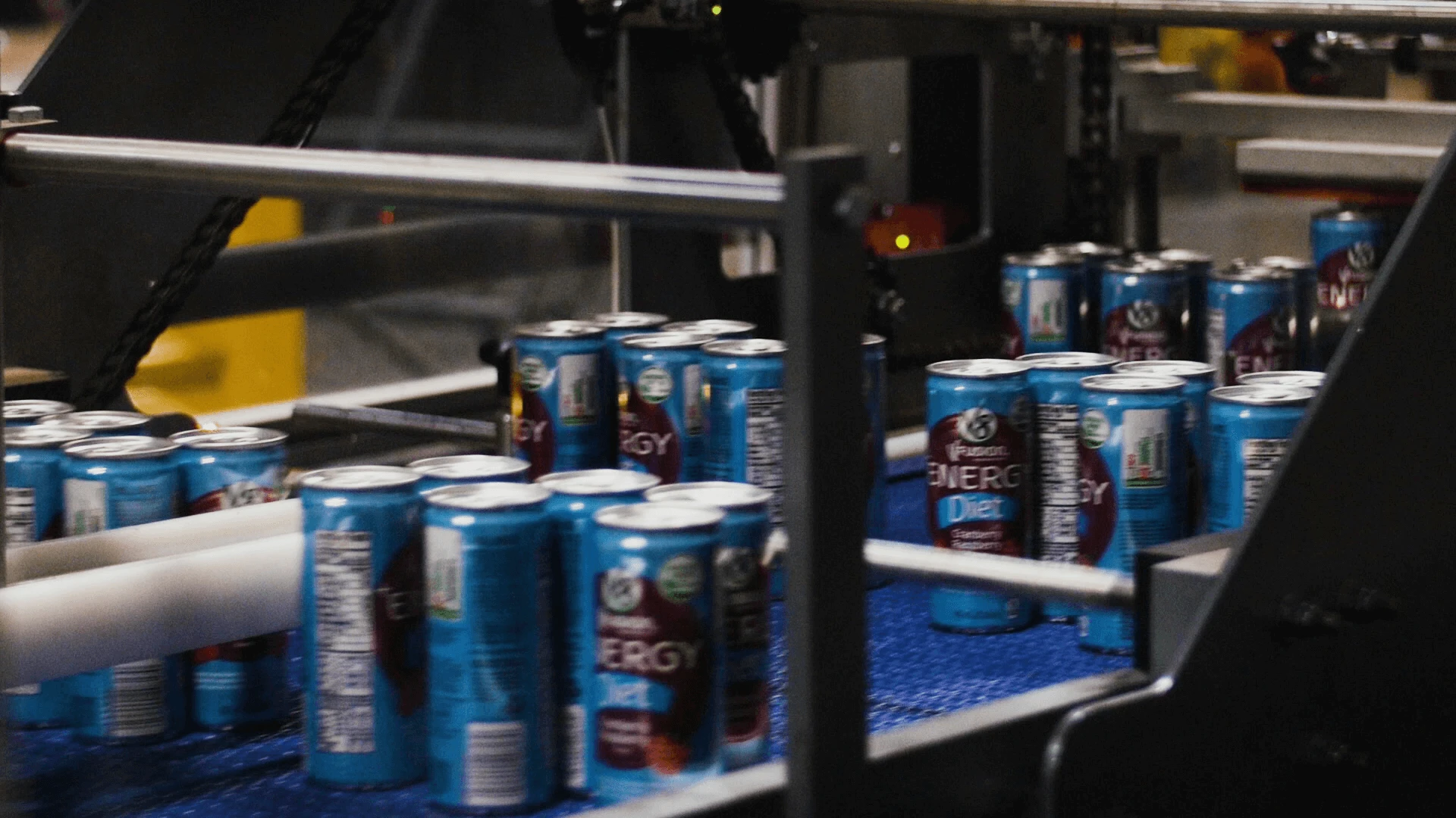 V8 energy cans running through a production line