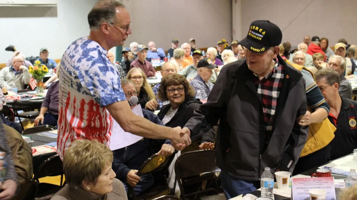 Bryan Keller shakes a veteran's hand at the K.A.V.I.C. dinner
