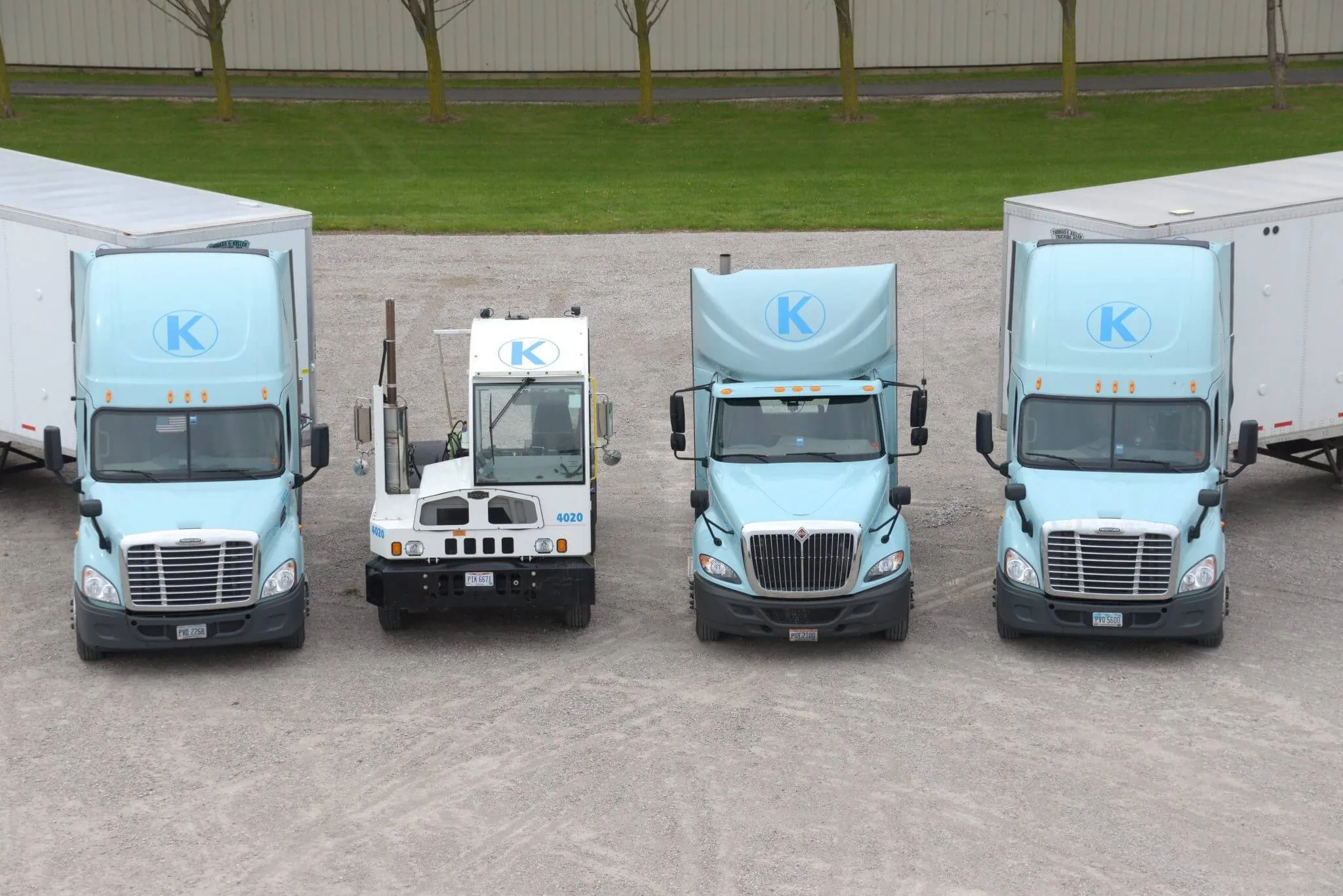 Front view of four trucks from Keller Trucking lined up